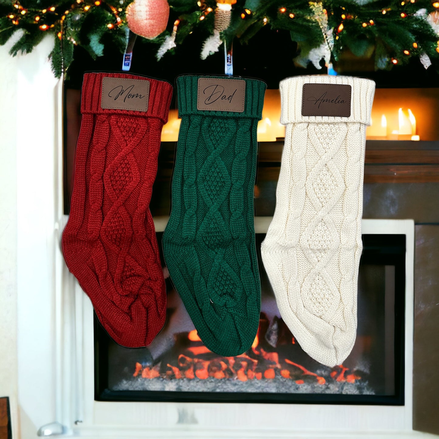 Three Christmas stockings labeled 'Ethan', 'Dad', and 'Mom' hanging on a fireplace mantle with decorative items.