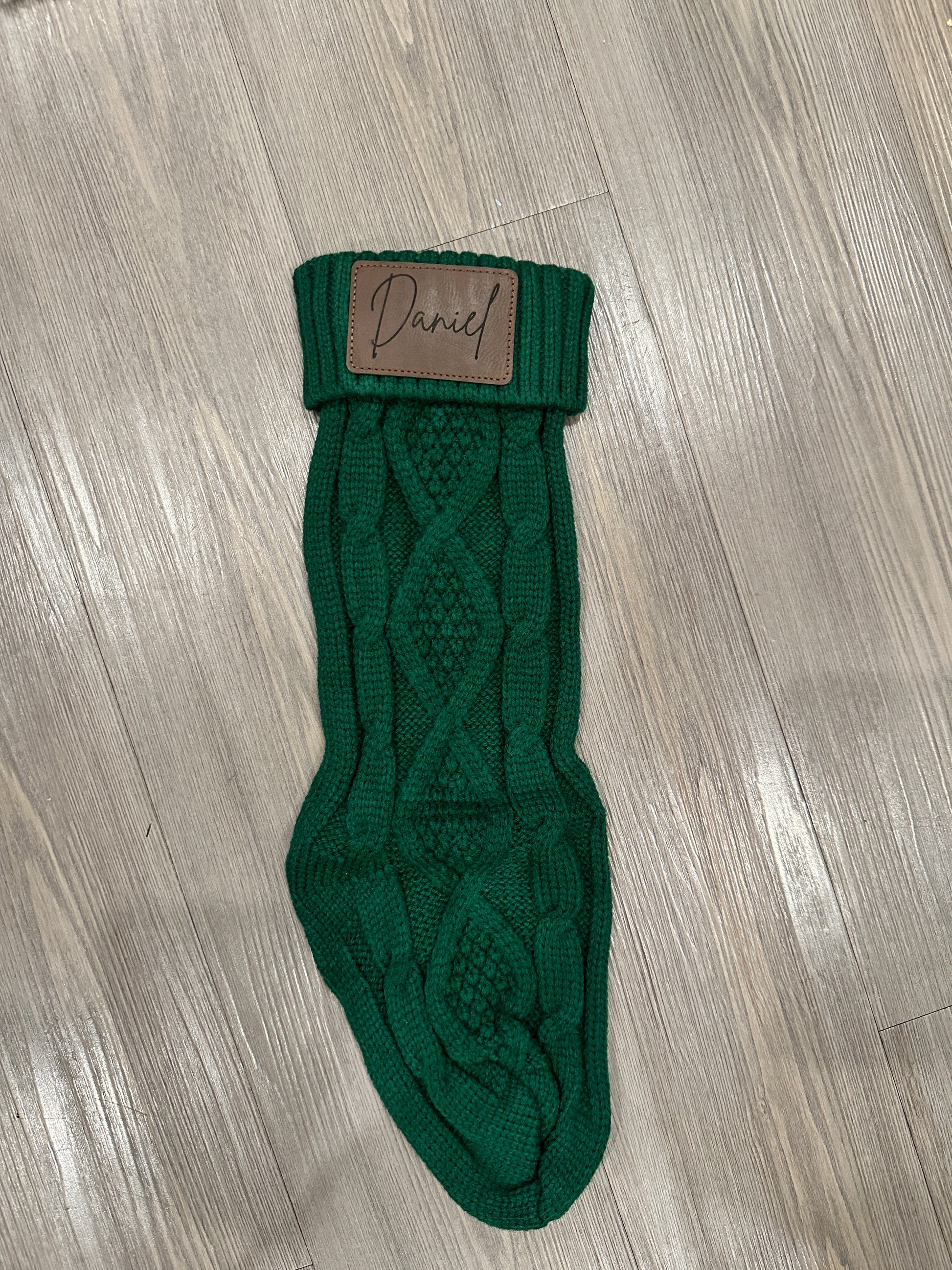 Christmas stockings labeled 'Ethan', 'Dad', and 'Mom' hanging on a fireplace mantle with decorative items.