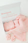 Pink baby outfit with matching headband and socks in a box, personalized with 'Brennan Reese'.